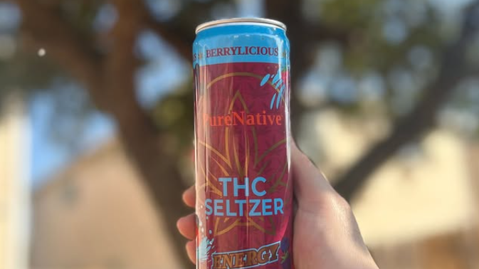 Berrylicious THC Seltzer in front of a tree.