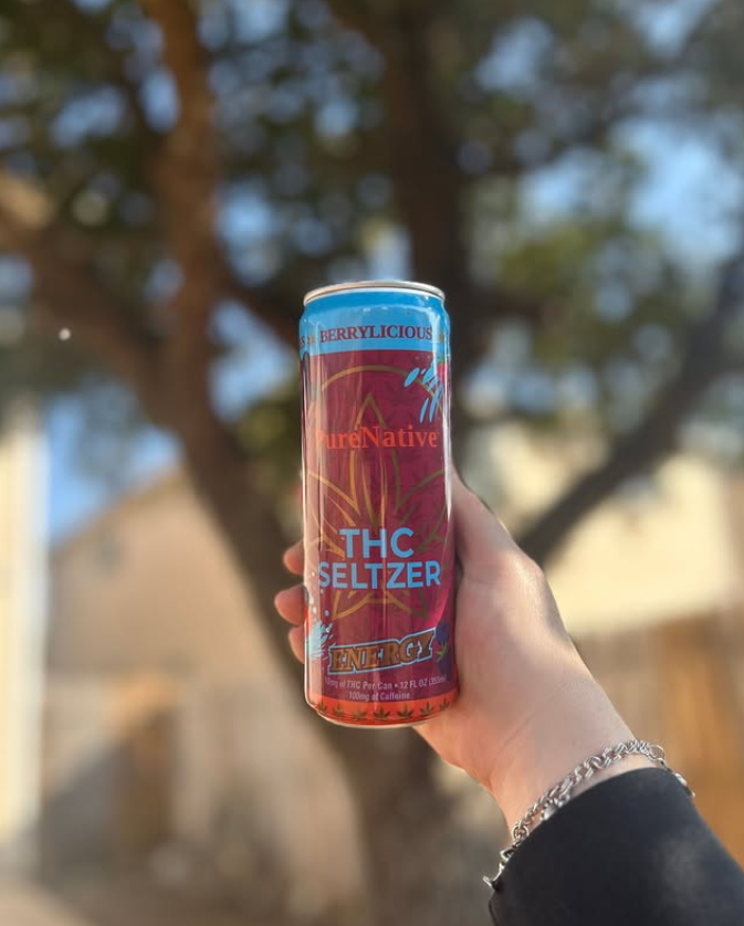 Berrylicious THC Seltzer in front of a tree.